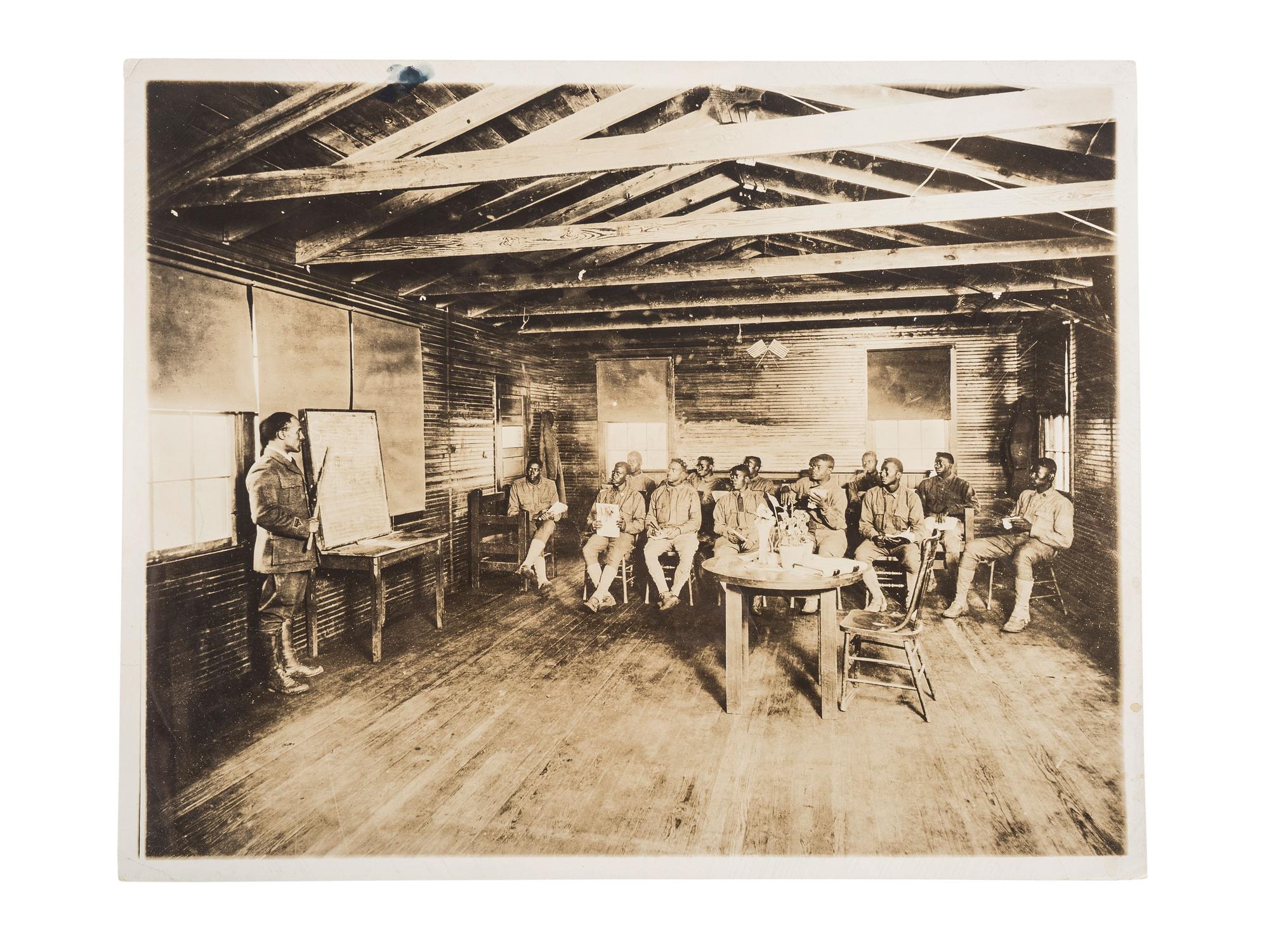 [EDUCATION]. Press photograph of African American soldiers from the 165th Depot Brigade learning to read at Camp Travis, San Antonio, TX. Boston, MA: Publicity Bureau, National War Work Council, YMCA, 24 September 1918.