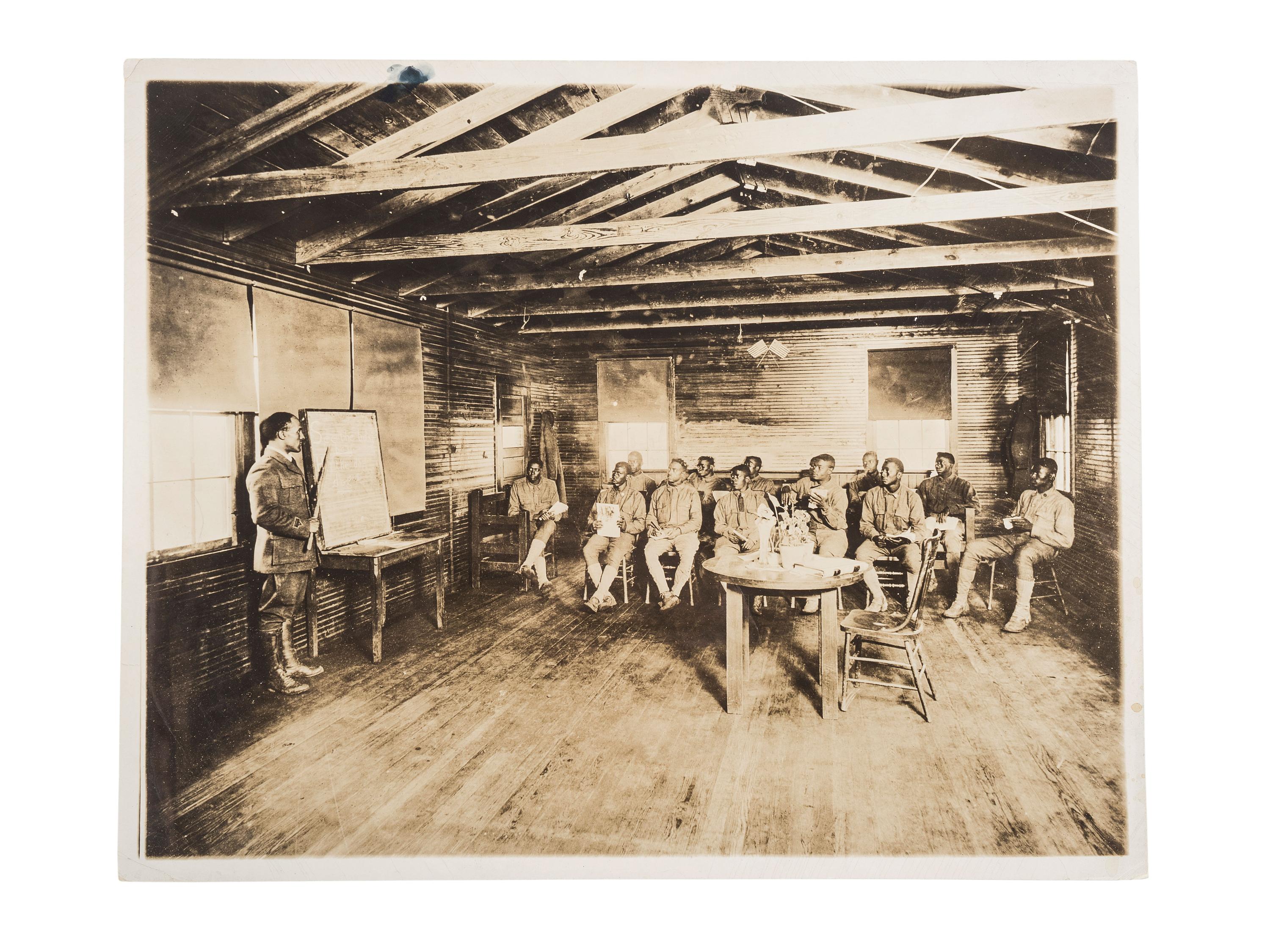 [EDUCATION]. Press photograph of African American soldiers from the 165th Depot Brigade learning to read at Camp Travis, San Antonio, TX. Boston, MA: Publicity Bureau, National War Work Council, YMCA, 24 September 1918.