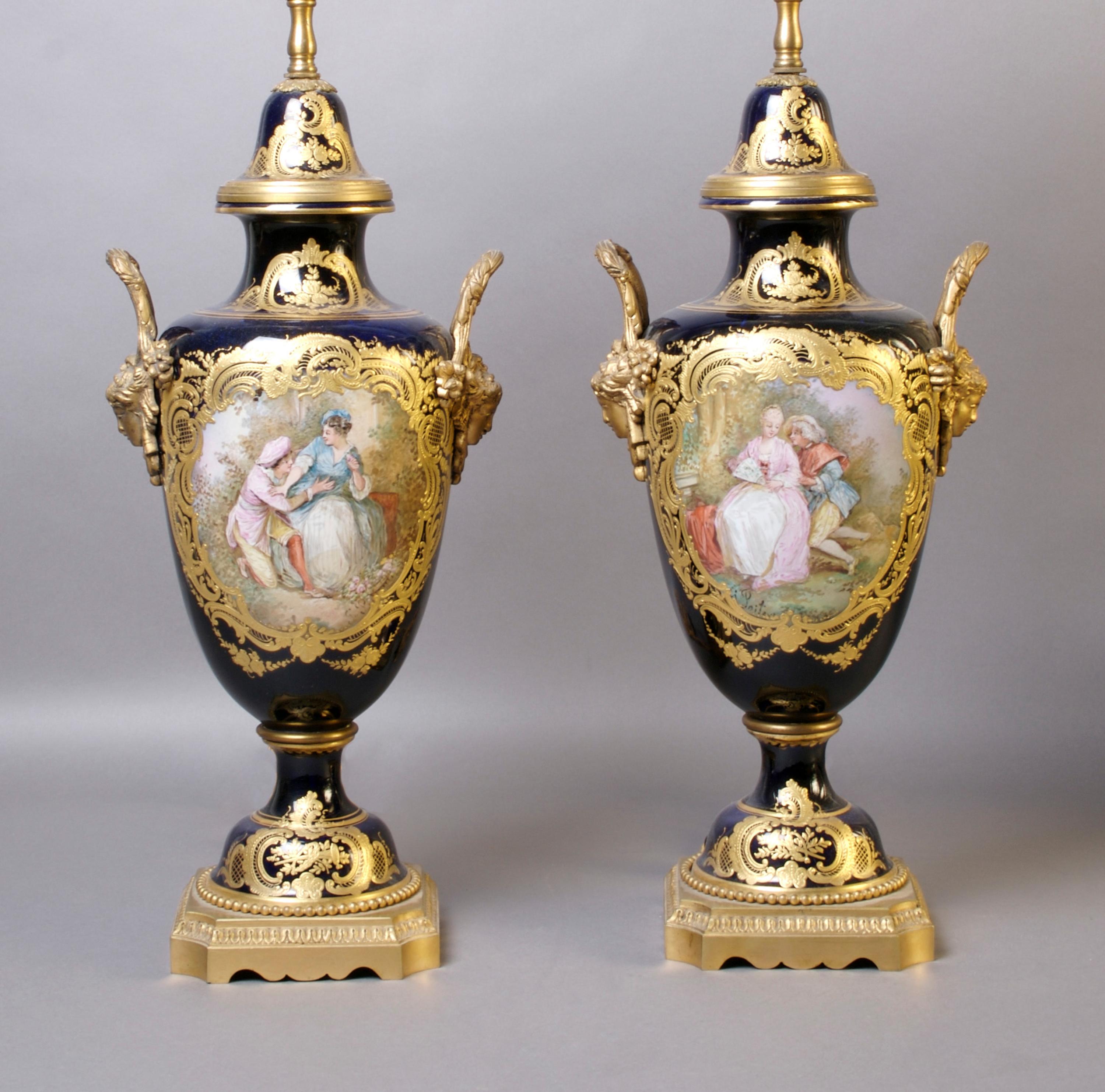 A Pair of Sevres Porcelain and Gilt Metal Mounted Covered Urns, Height 16 1/4 inches.