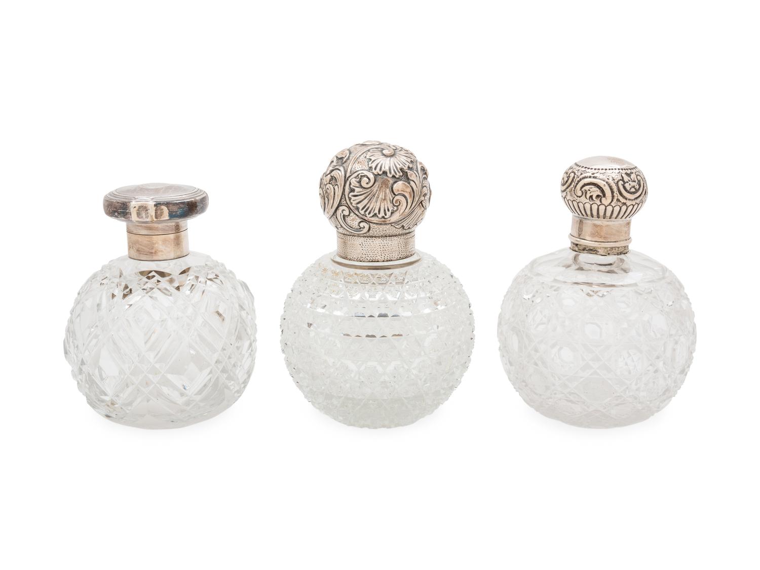 Three English Silver Mounted Cut Glass Bottles