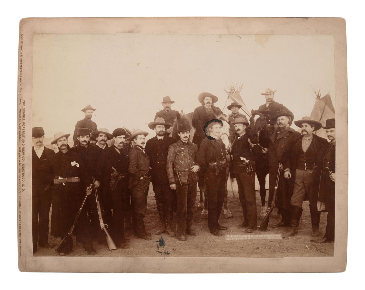 GRABILL, John C.H. (1849-1903), photographer. Photograph of William F. "Buffalo Bill" Cody with war correspondents and US Cavalry officers at Pine Ridge, 1891.