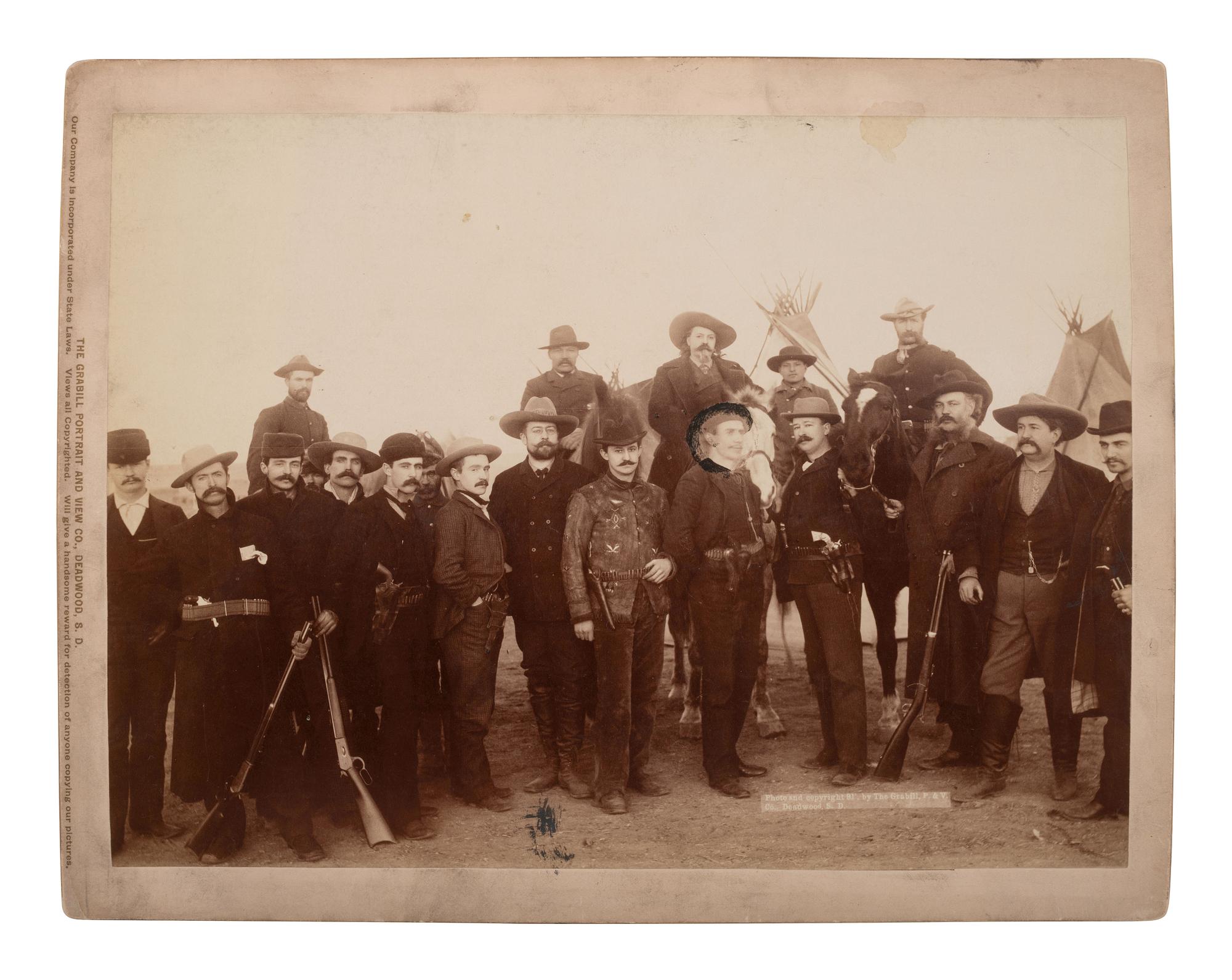 GRABILL, John C.H. (1849-1903), photographer. Photograph of William F. "Buffalo Bill" Cody with war correspondents and US Cavalry officers at Pine Ridge, 1891.