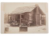 [EARLY PHOTOGRAPHY]. A group of 2 cabinet photographs of African American families posing in front of log cabins. Ca 1890s.