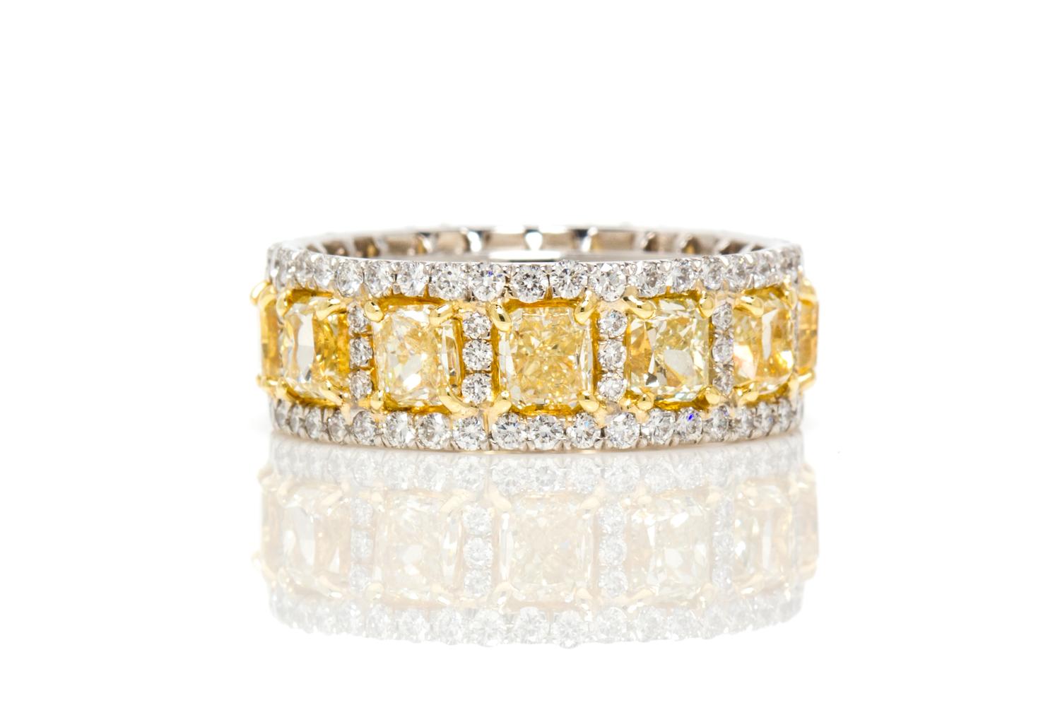 A Platinum, Yellow Gold, Fancy Yellow Diamond and Diamond Eternity Band Ring, 7.90 dwts.