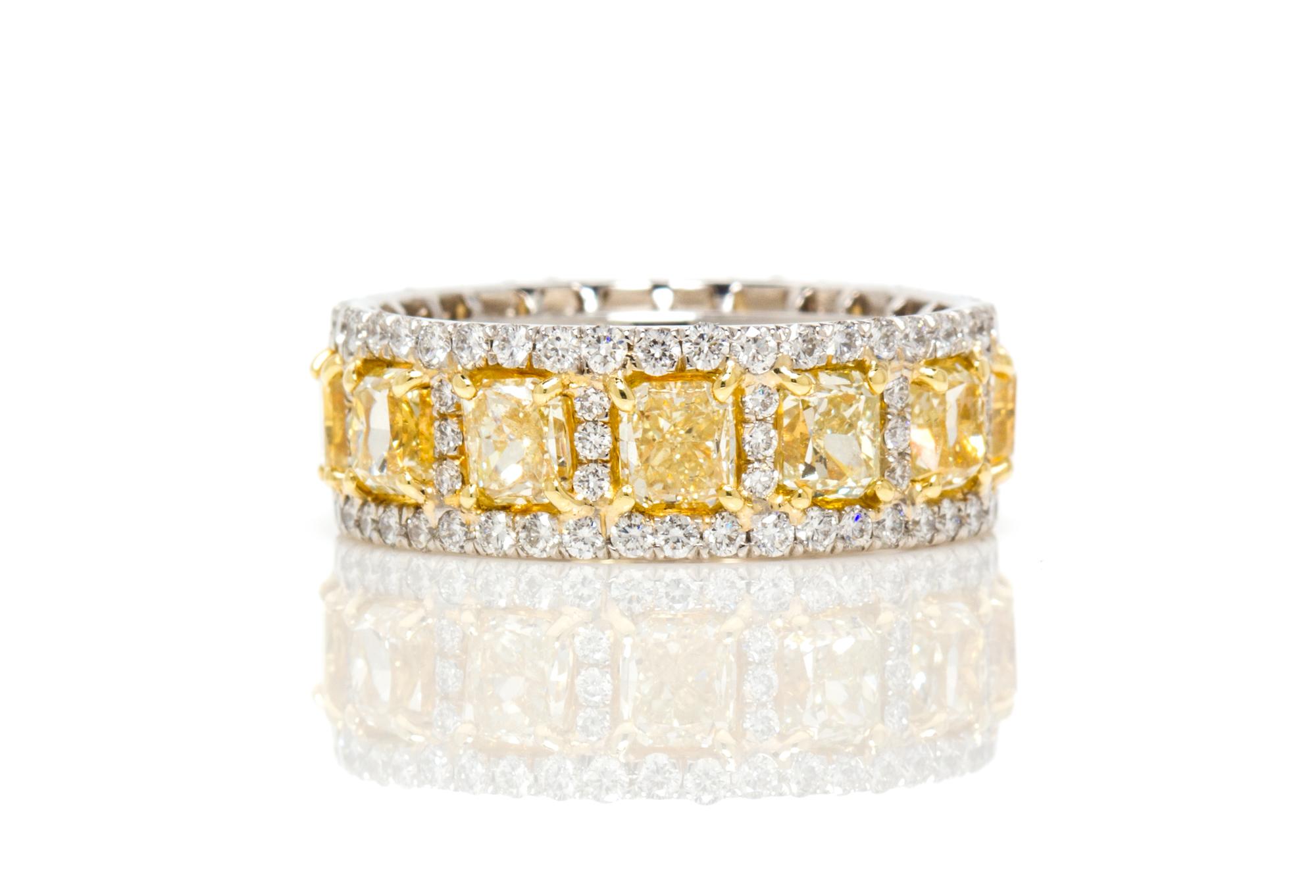 A Platinum, Yellow Gold, Fancy Yellow Diamond and Diamond Eternity Band Ring, 7.90 dwts.