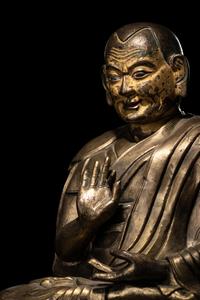 A Large Tibetan Parcel Gilt Bronze Repoussé Figure of a Seated Monk