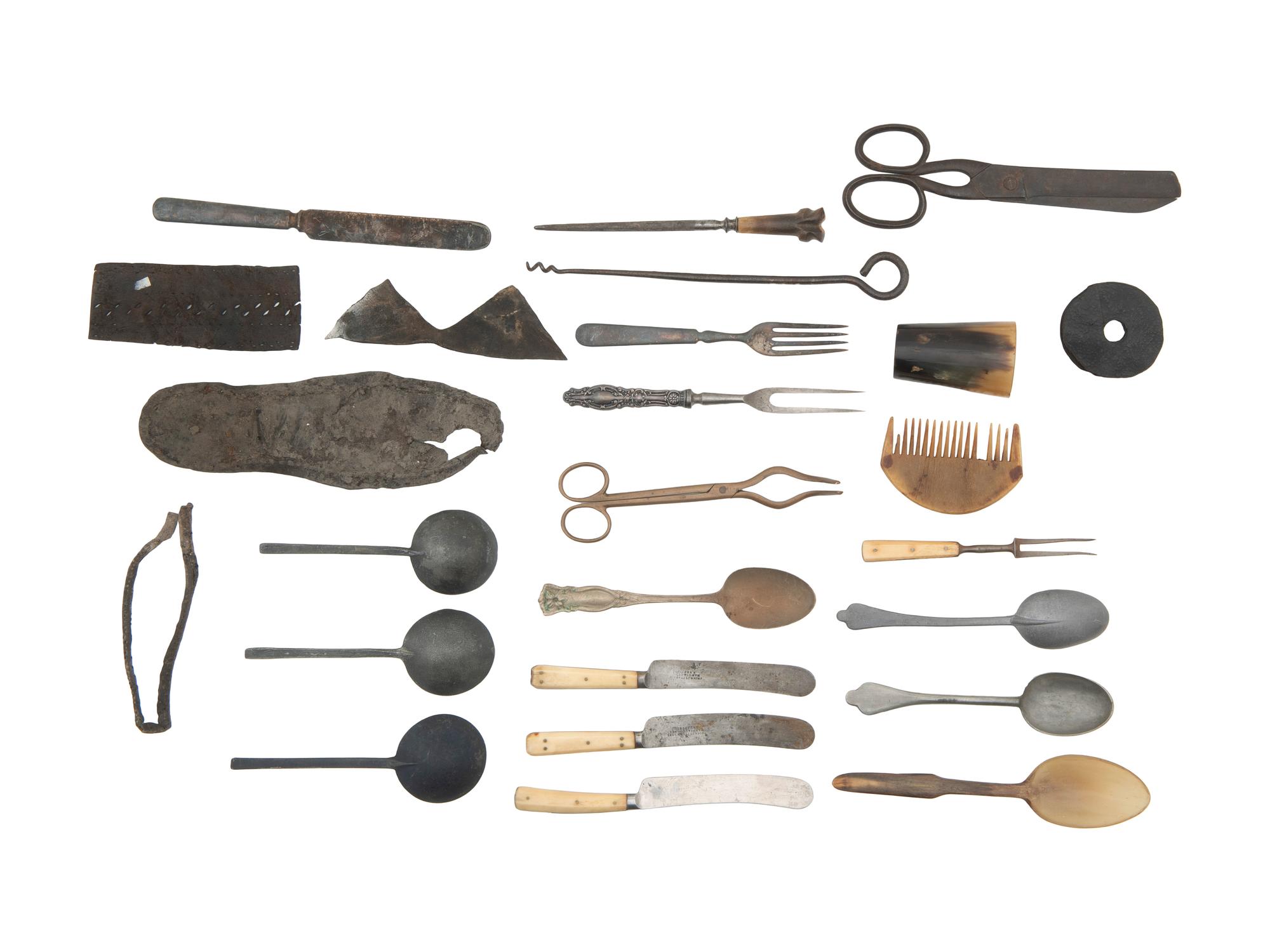 [CAMP LIFE]. A group of branding irons, utensils, and other camp tools.