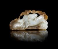 A Chinese Carved Russet and White Jade Figural Group of Double Rams Length 2 5/8 inches. — QING DYNASTY (1644-1912)