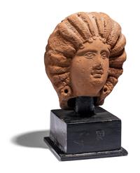 A Roman Terracotta Head of a Female with Melon Coiffure