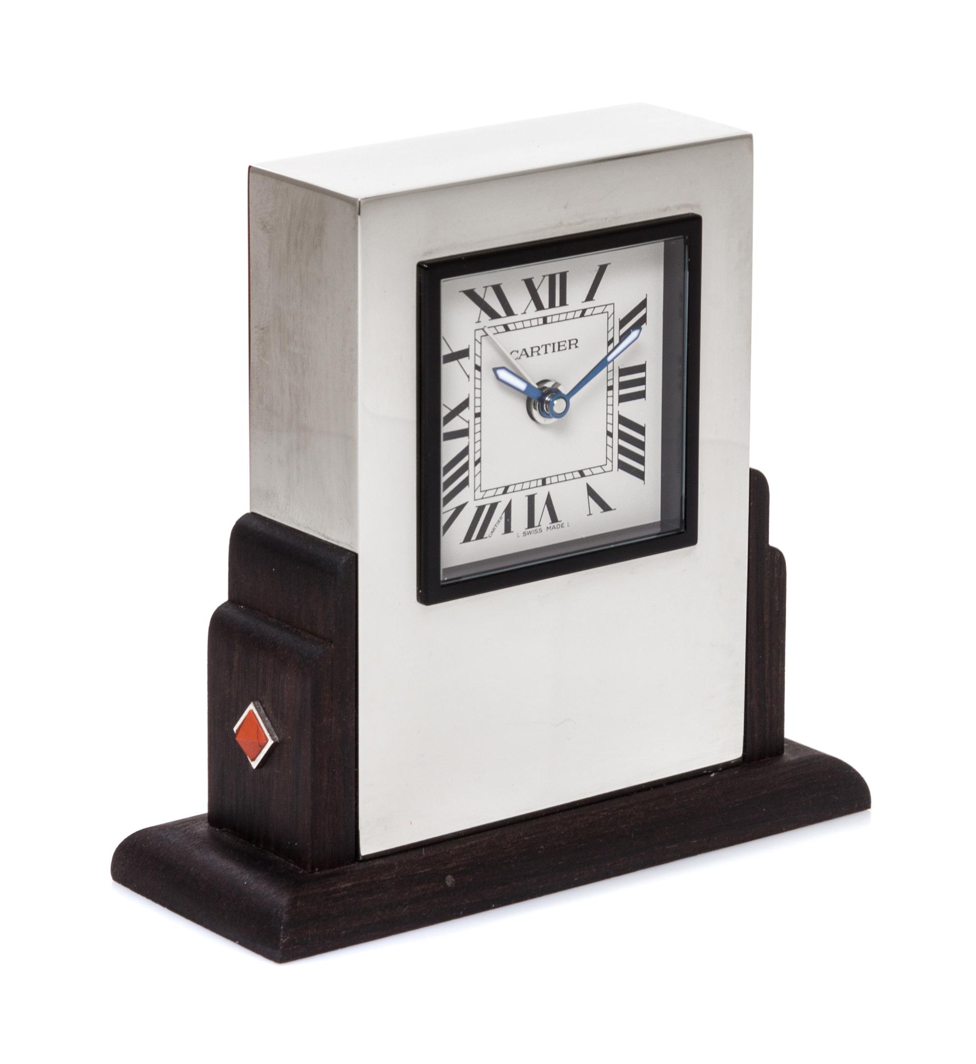 A Cartier Art Deco Style Travel Alarm Clock Height 3 1/2 x width 3 3/8 x depth 1 3/8 inches. — 20TH CENTURY