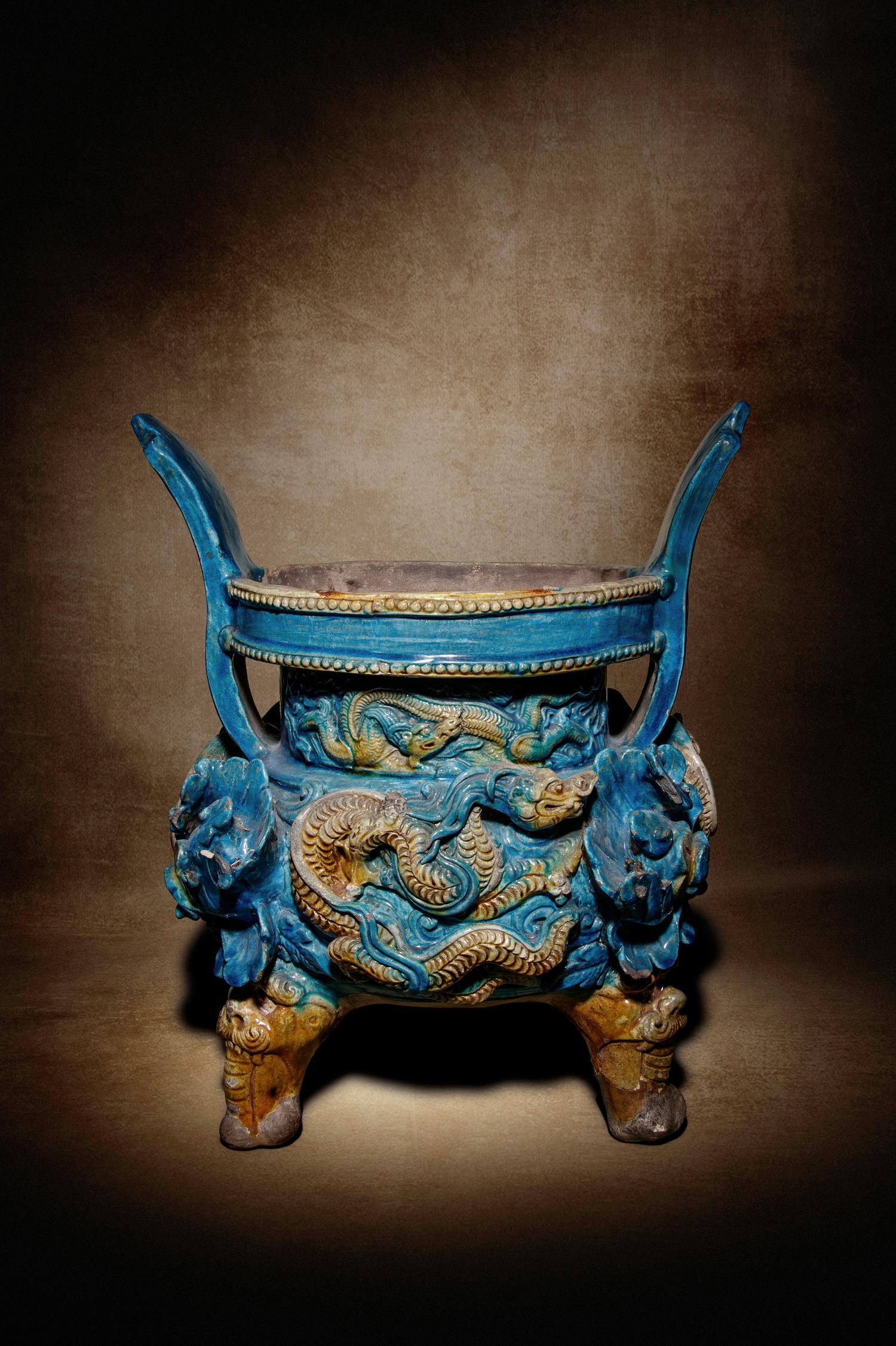 A Turquoise and Ochre Glazed Tileworks Tripod Incense Burner