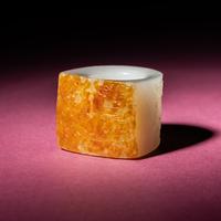 A Chinese Russet and White Jade 'Taotie and Chilong' Archer's Ring, 18th Century — 清中期 白玉留皮饕餮螭龍紋扳指