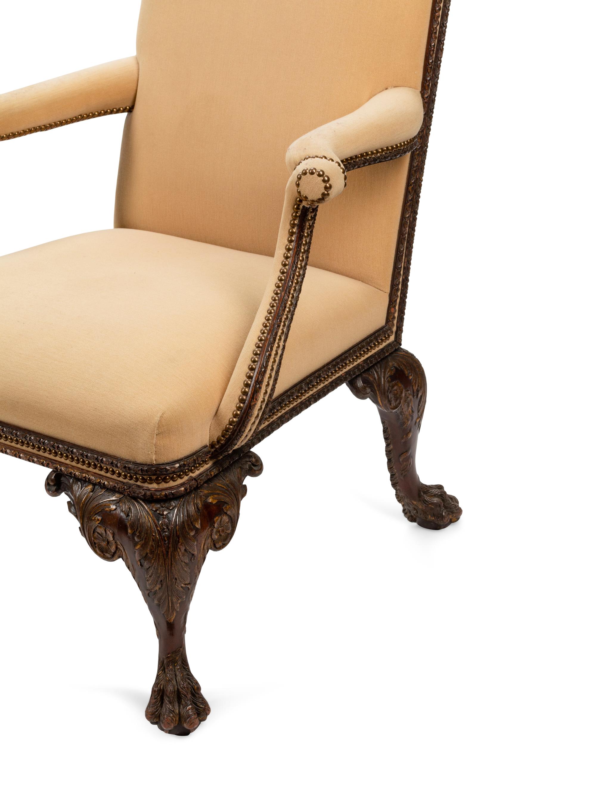 A Pair of Irish George II Style Parcel Gilt Carved Mahogany Library Chairs