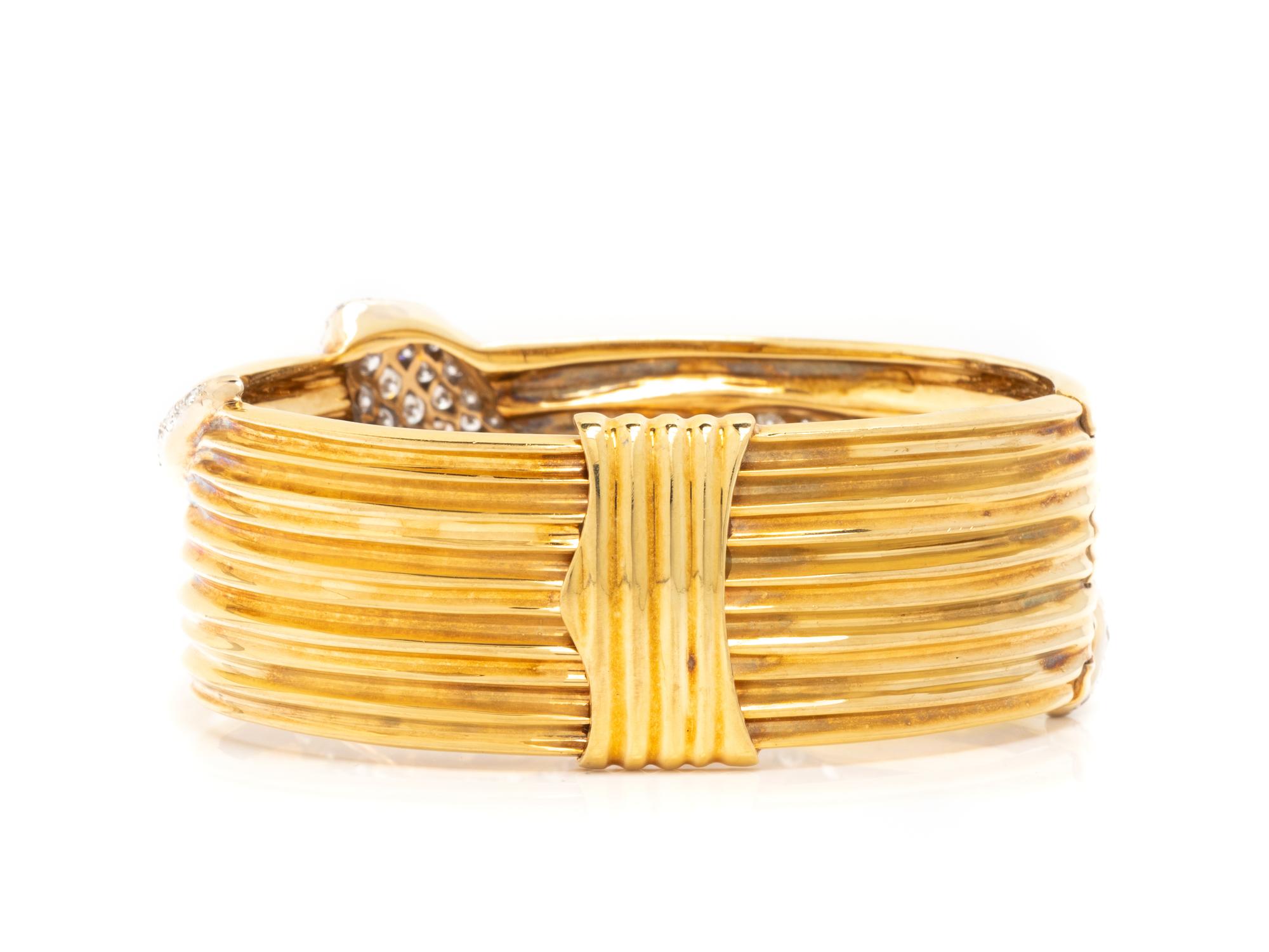YELLOW GOLD, DIAMOND, AND EMERALD SNAKE BANGLE BRACELET