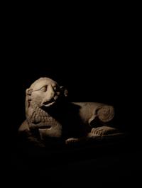 An Egyptian Limestone Recumbent Lion