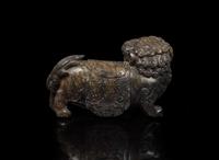 A Chinese carved mottled dark brown soapstone Buddhist lion, 18th century or earlier 壽山石獅子 十八世紀或更早