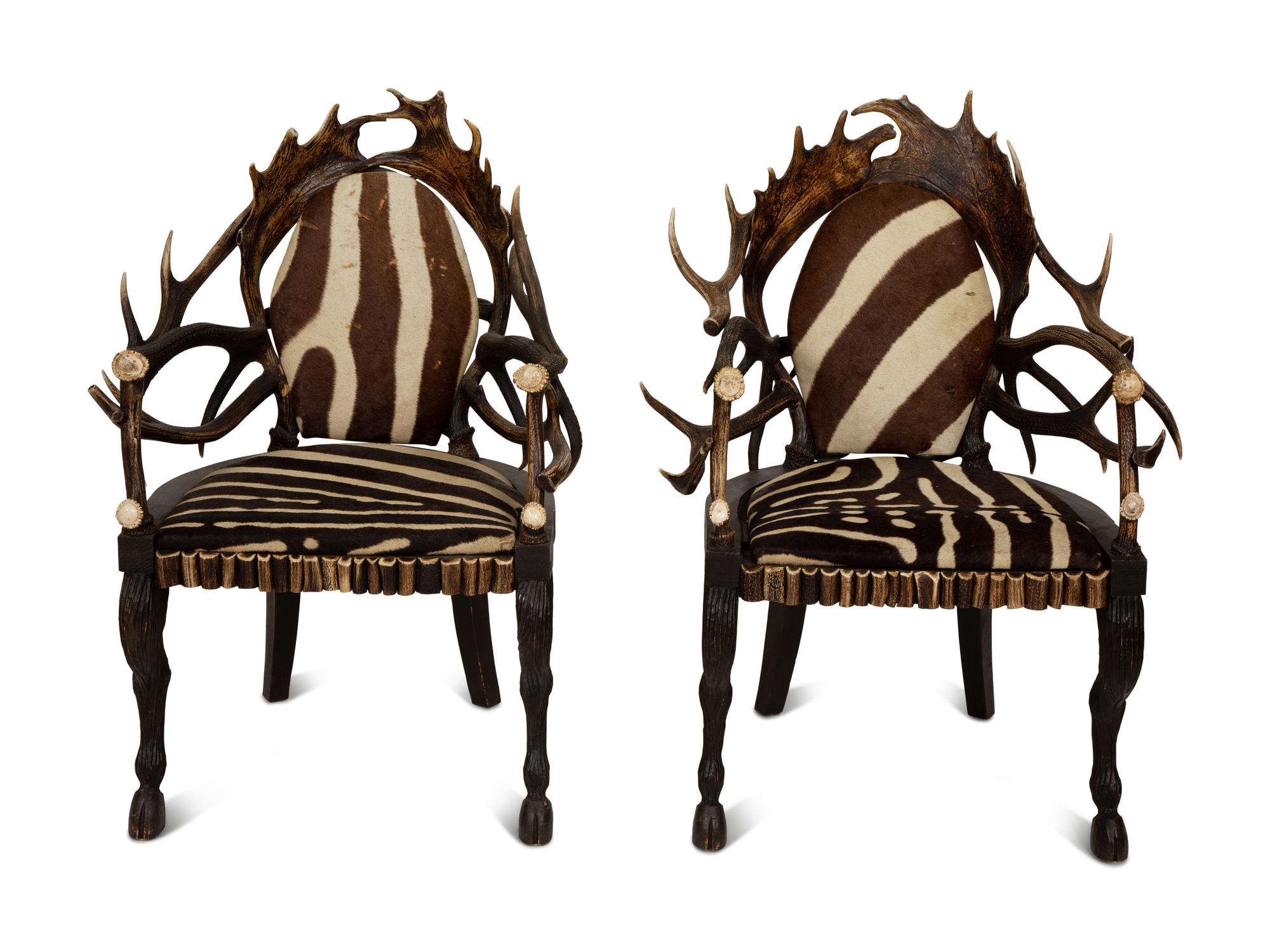 A Pair of Stag Antler Arm Chairs with Zebra Hide Upholstery Attributed to Anthony Redmile