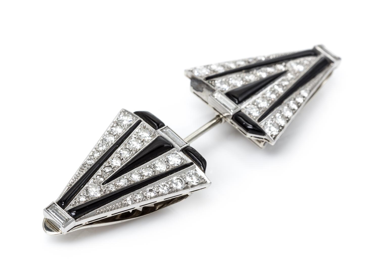An Art Deco Platinum, White Gold, Diamond and Onyx Convertible Dress Clips/Jabot, 16.70 dwts.