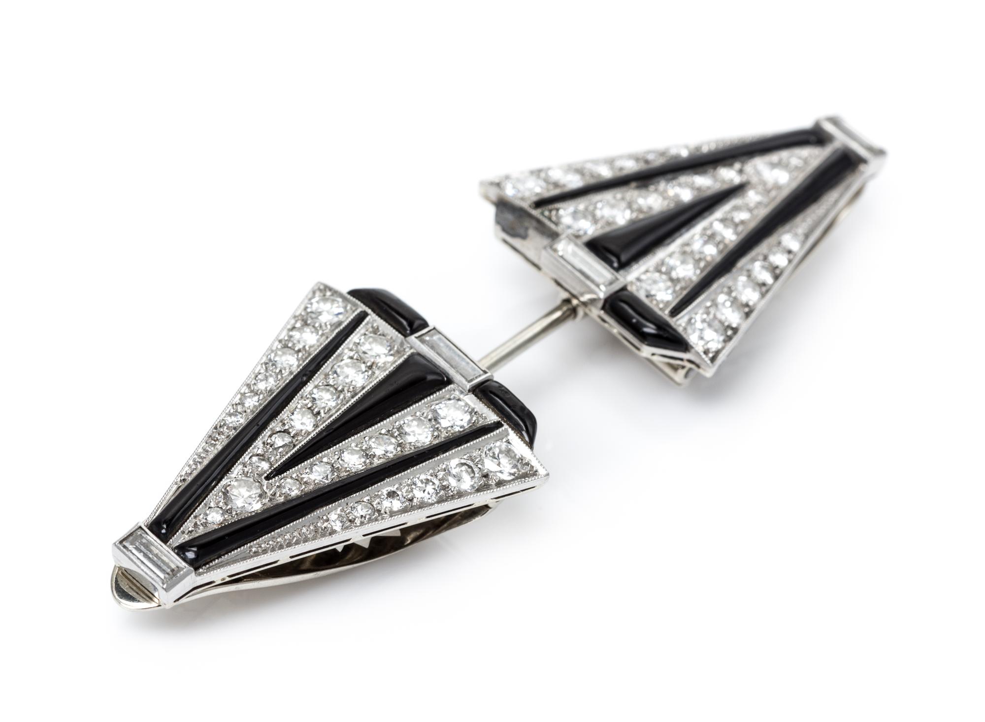 An Art Deco Platinum, White Gold, Diamond and Onyx Convertible Dress Clips/Jabot, 16.70 dwts.