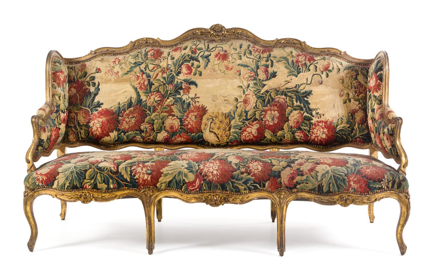 A Louis XV Giltwood Canape a Oreilles Height 45 1/8 x width 76 x depth 25 1/2 inches. — LATE 18TH/EARLY 19TH CENTURY