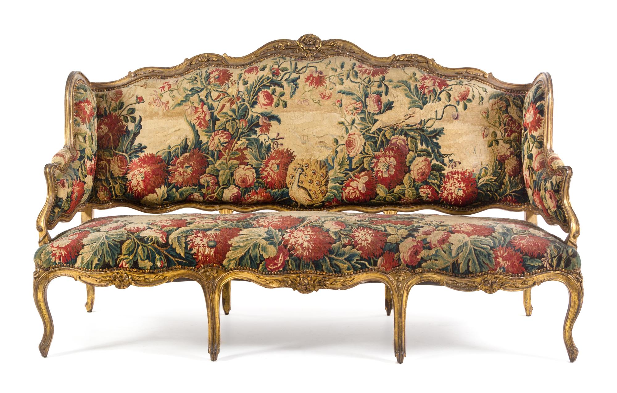 A Louis XV Giltwood Canape a Oreilles Height 45 1/8 x width 76 x depth 25 1/2 inches. — LATE 18TH/EARLY 19TH CENTURY
