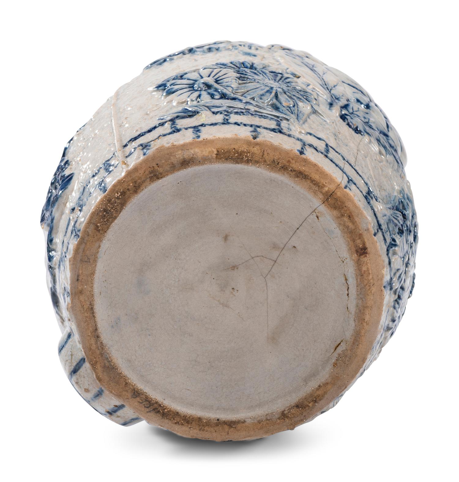 A Cobalt-Decorated Molded Stoneware Water Cooler with Bear Decoration