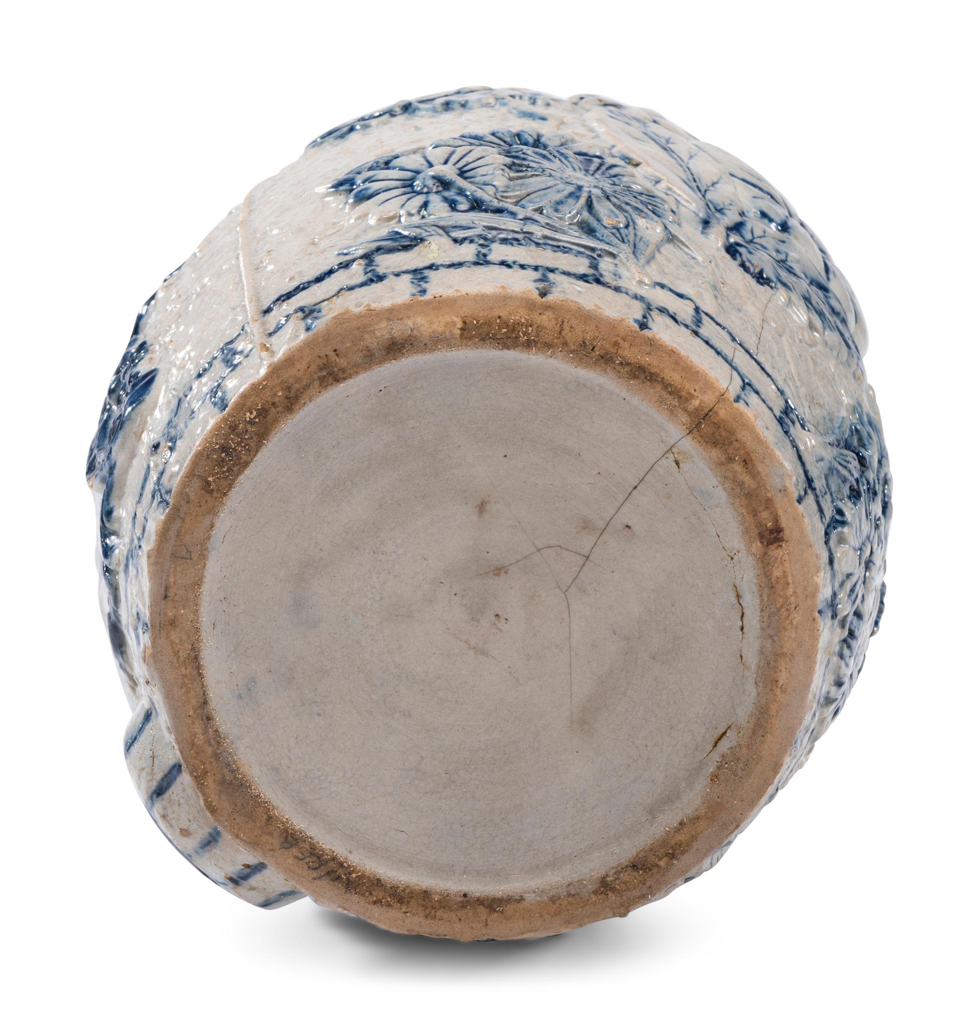 A Cobalt-Decorated Molded Stoneware Water Cooler with Bear Decoration