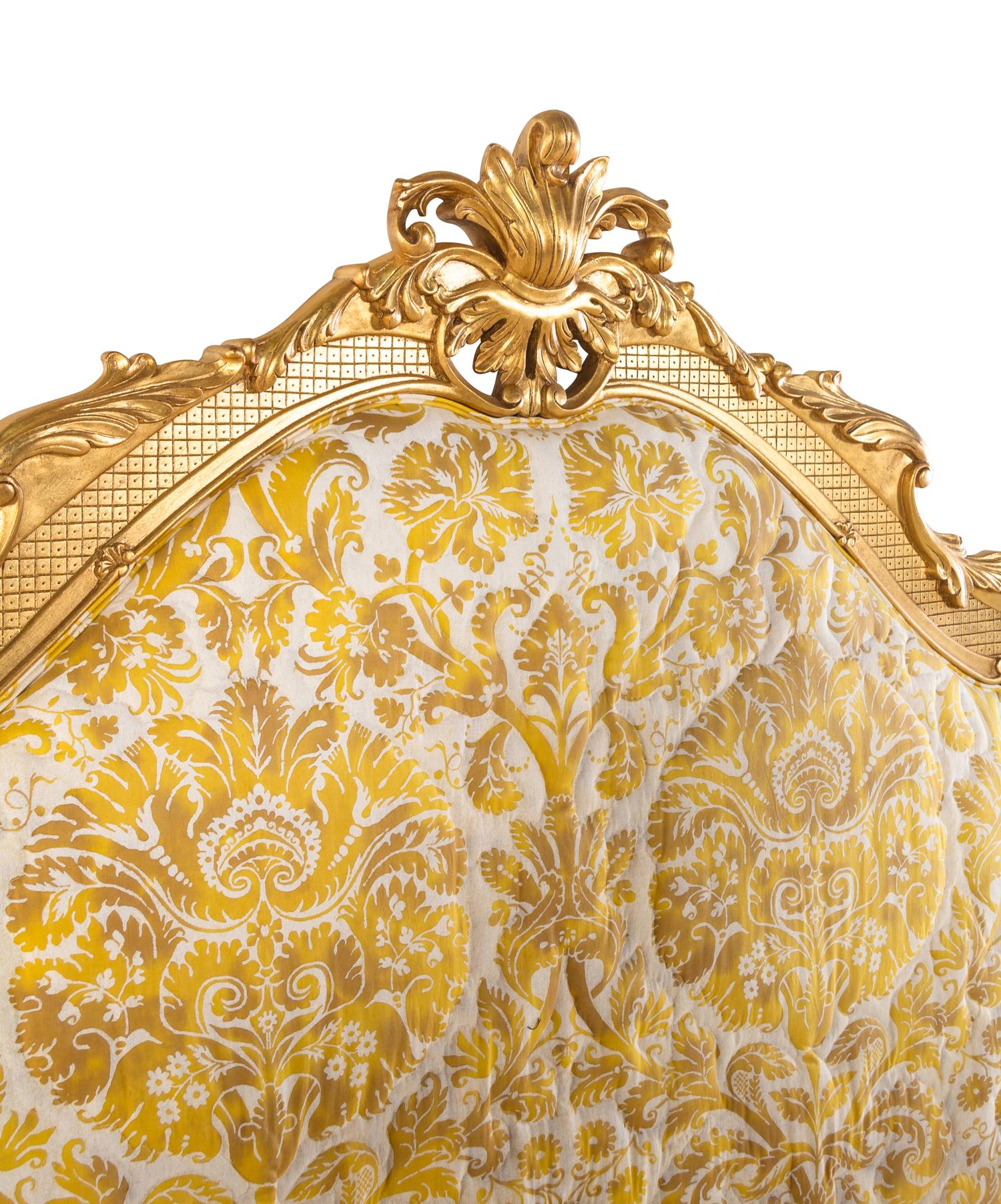 A Giltwood Headboard with Fortuny Upholstery