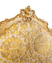 A Giltwood Headboard with Fortuny Upholstery