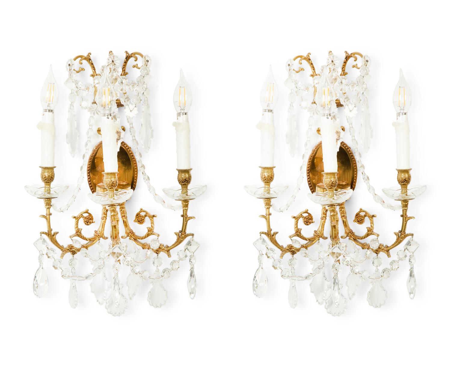 A Pair of Gilt Metal and Cut Glass Three-Light Wall Lights