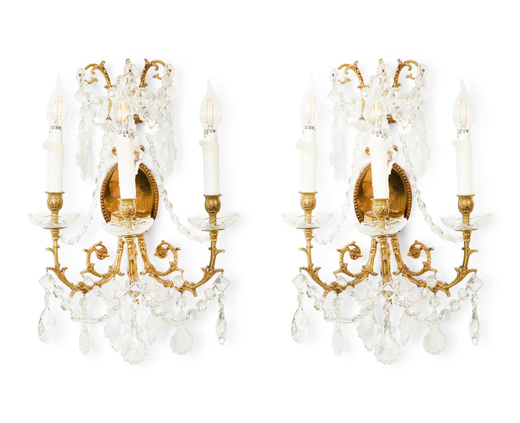 A Pair of Gilt Metal and Cut Glass Three-Light Wall Lights