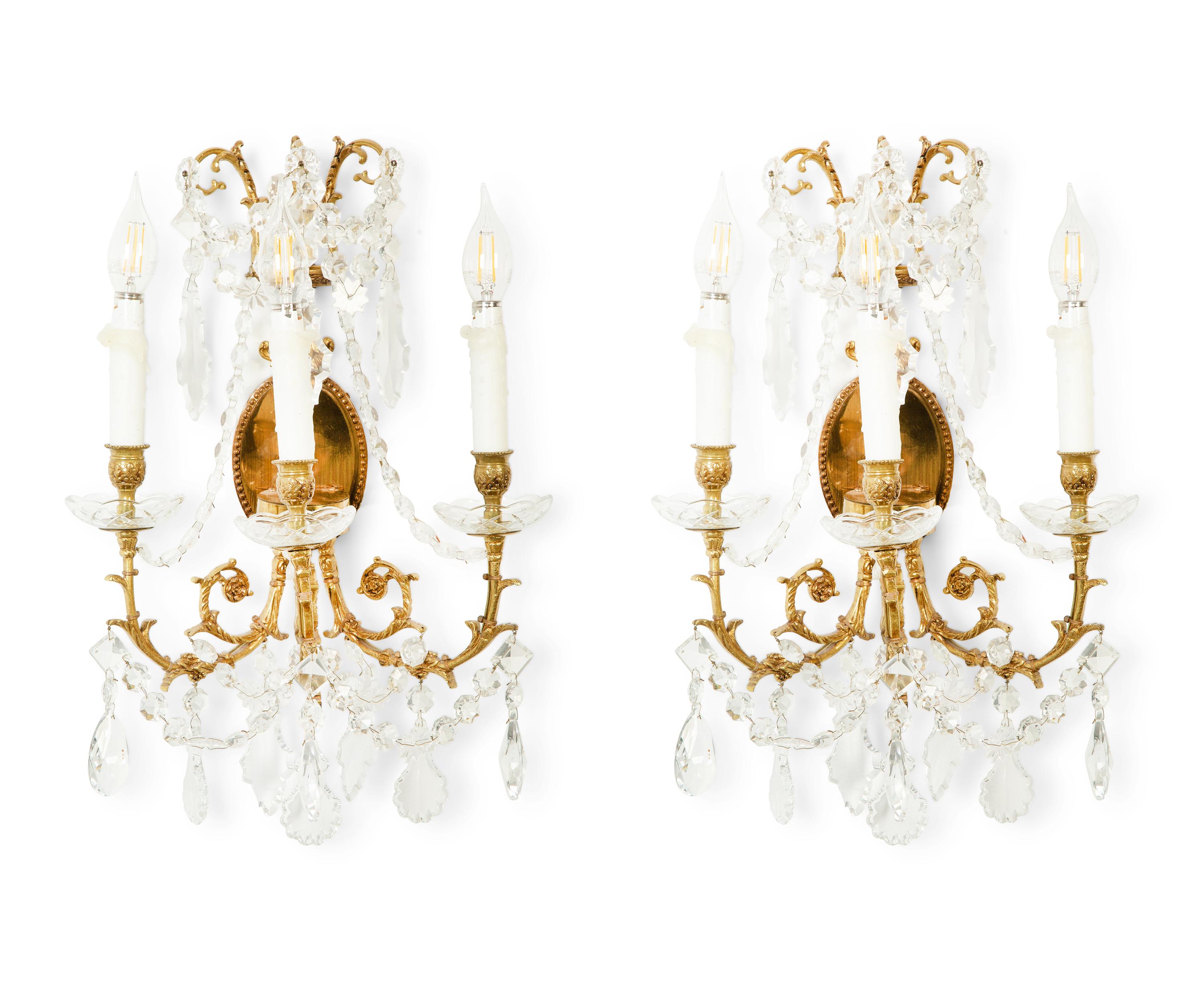 A Pair of Gilt Metal and Cut Glass Three-Light Wall Lights
