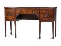 A Regency Carved, Inlaid and Figured Mahogany Bowfront Sideboard