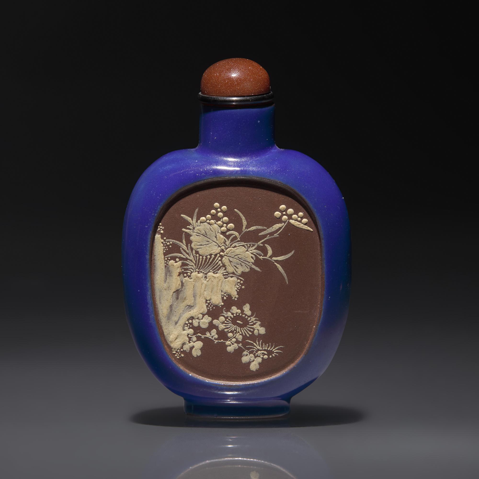 A Chinese Enameled Yixing Stoneware Snuff Bottle, Qing Dynasty, Circa 1820-1860 — 1820-1860年 宜興紫砂藍釉開光山水花卉紋鼻煙壺