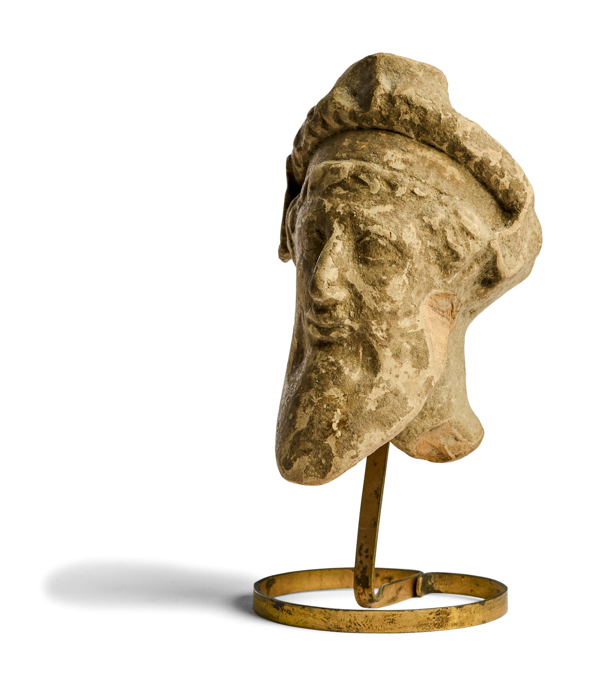 A Greek Terracotta Head of a Satyr