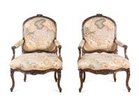 A Pair of Louis XV Style Carved Walnut Fauteuils