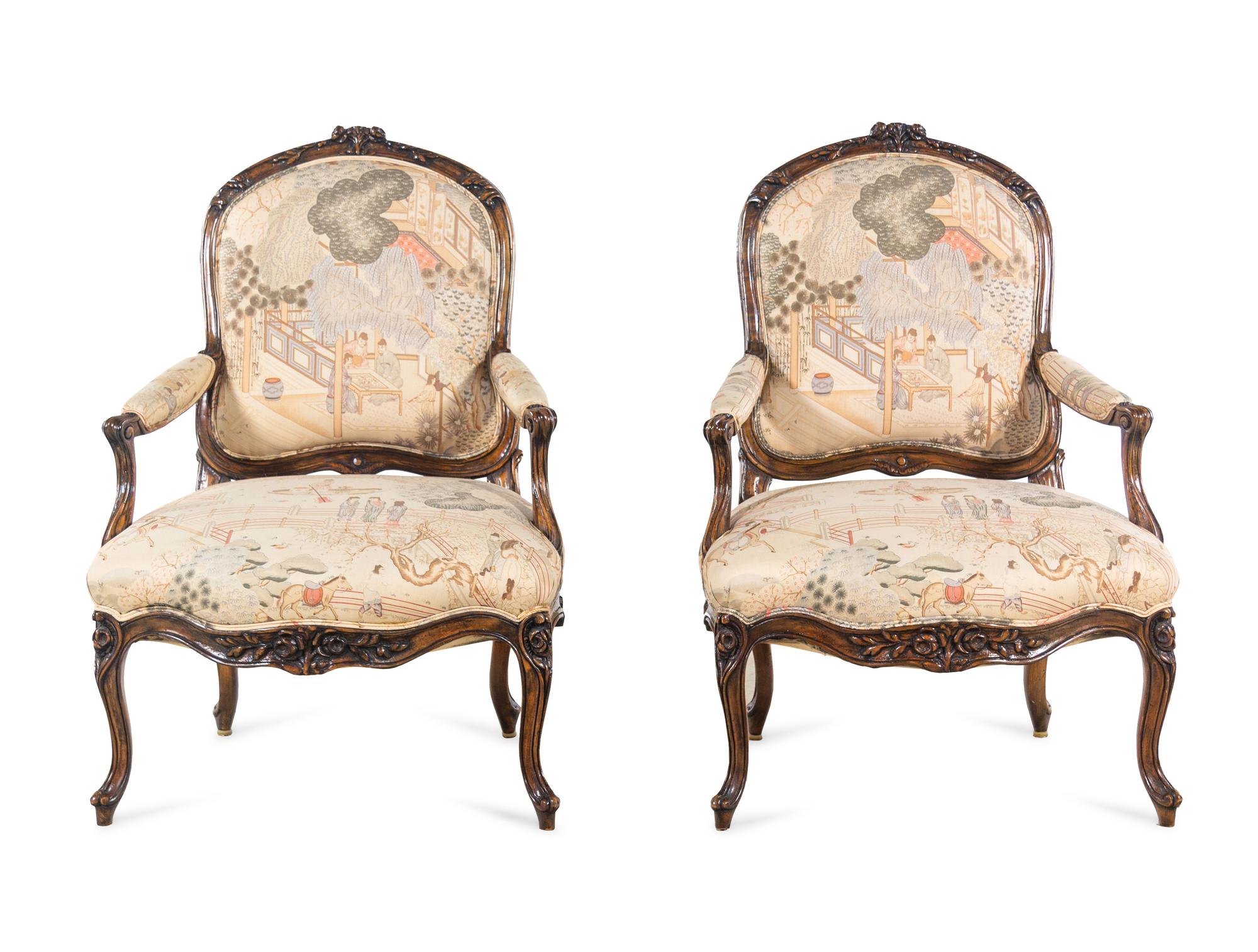 A Pair of Louis XV Style Carved Walnut Fauteuils