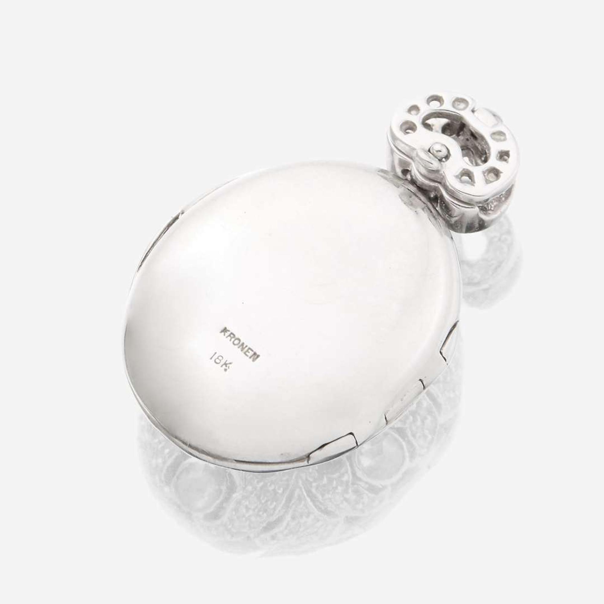 An eighteen karat white gold and diamond pendant locket