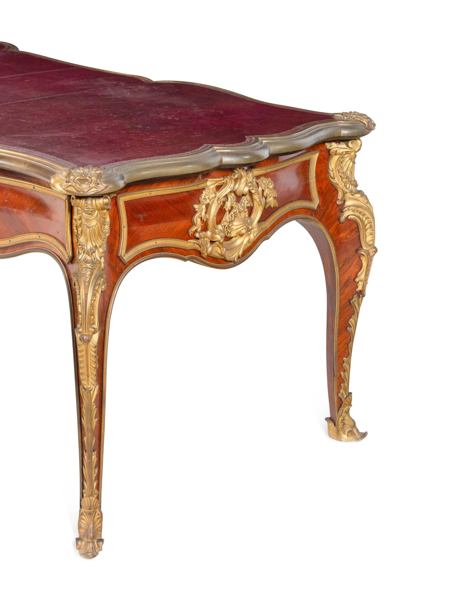 A Louis XV Style Gilt Bronze Mounted and Tooled Leather-Inset Tulipwood Bureau Plat