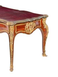 A Louis XV Style Gilt Bronze Mounted and Tooled Leather-Inset Tulipwood Bureau Plat