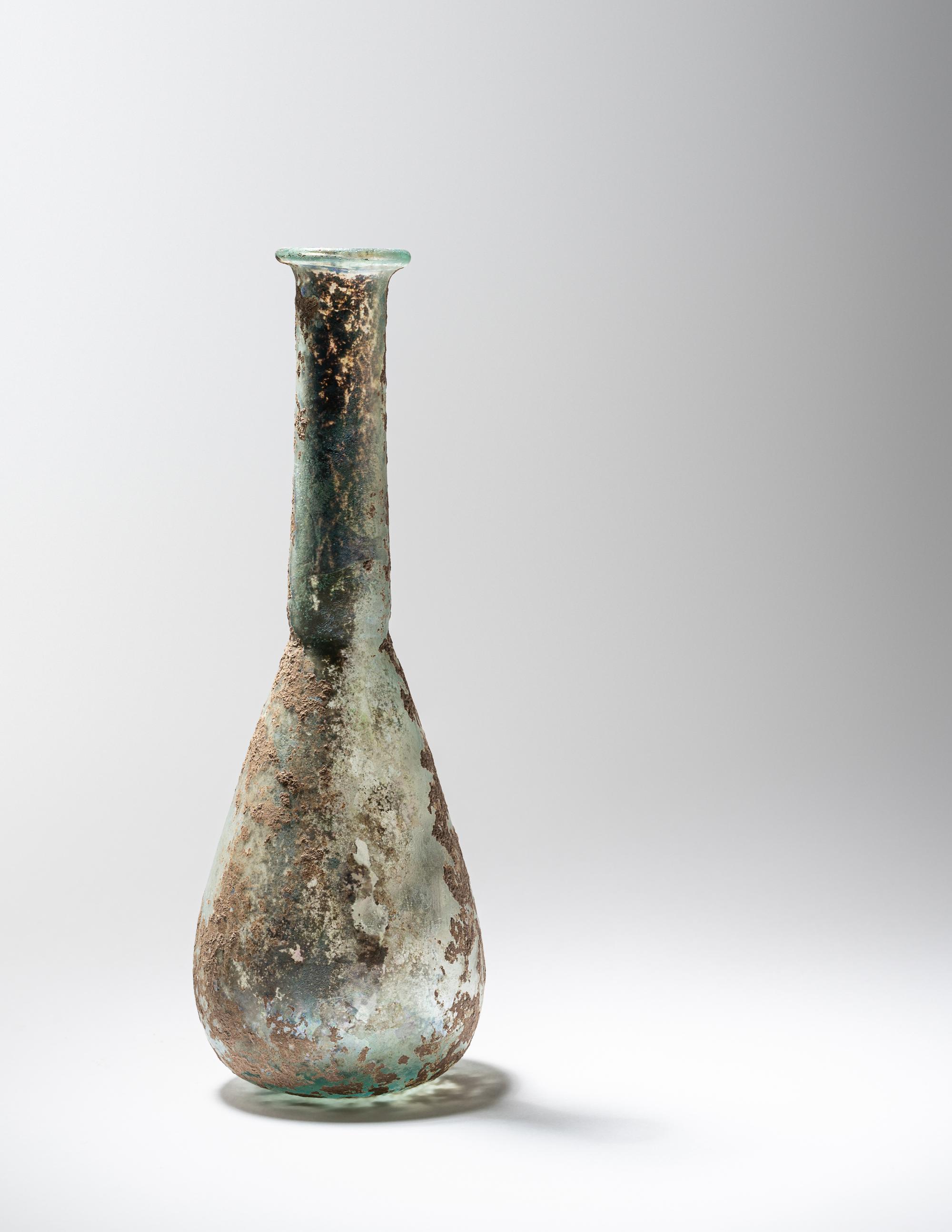 A Roman Pale Blue Glass Unguentarium