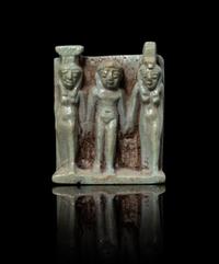 An Egyptian Faience Triad Amulet Height 1 5/8 x width 1 1/4 inches. — LATE PERIOD, DYNASTY 26, 664-525 B.C.E.