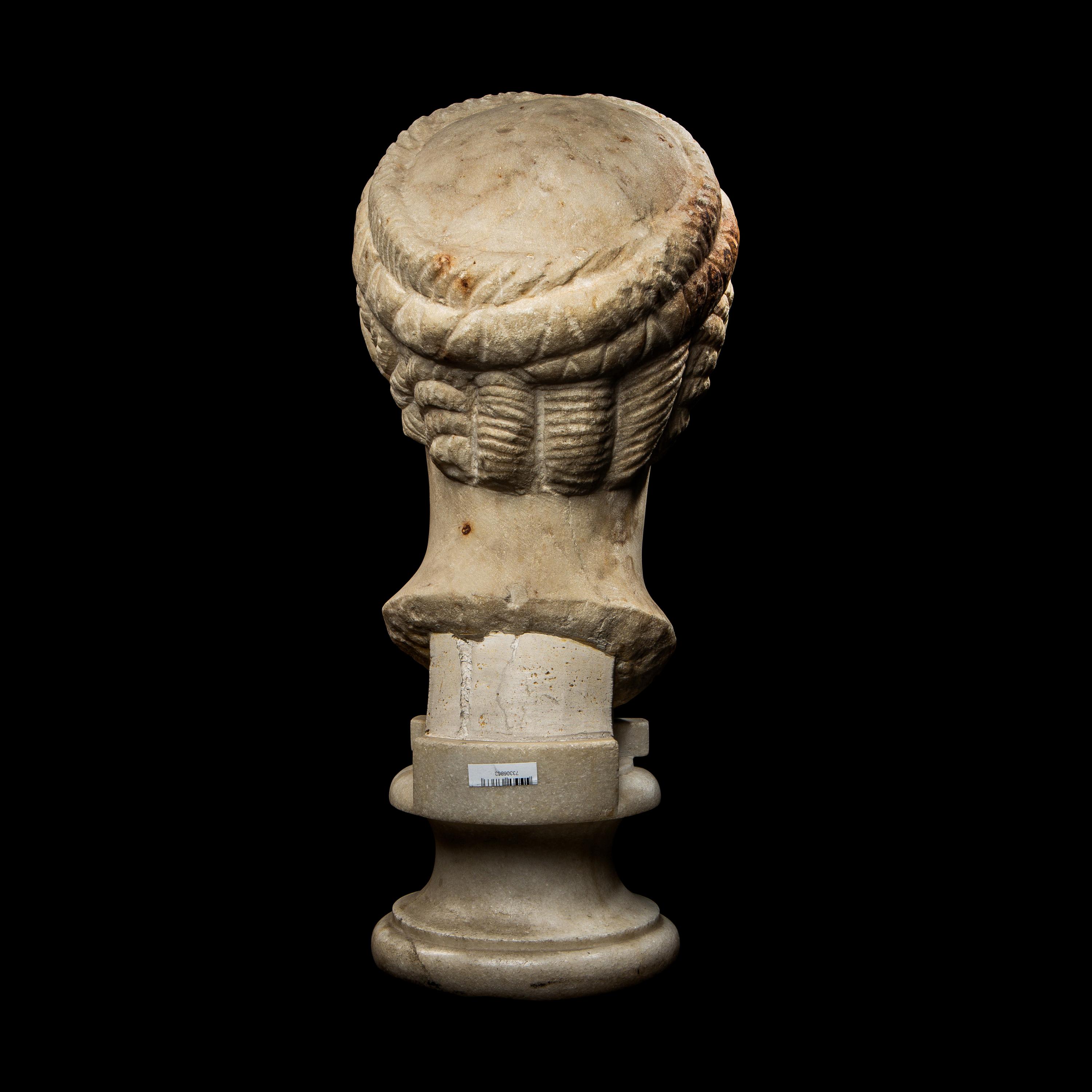A Roman Marble Archaistic Head of a Goddess