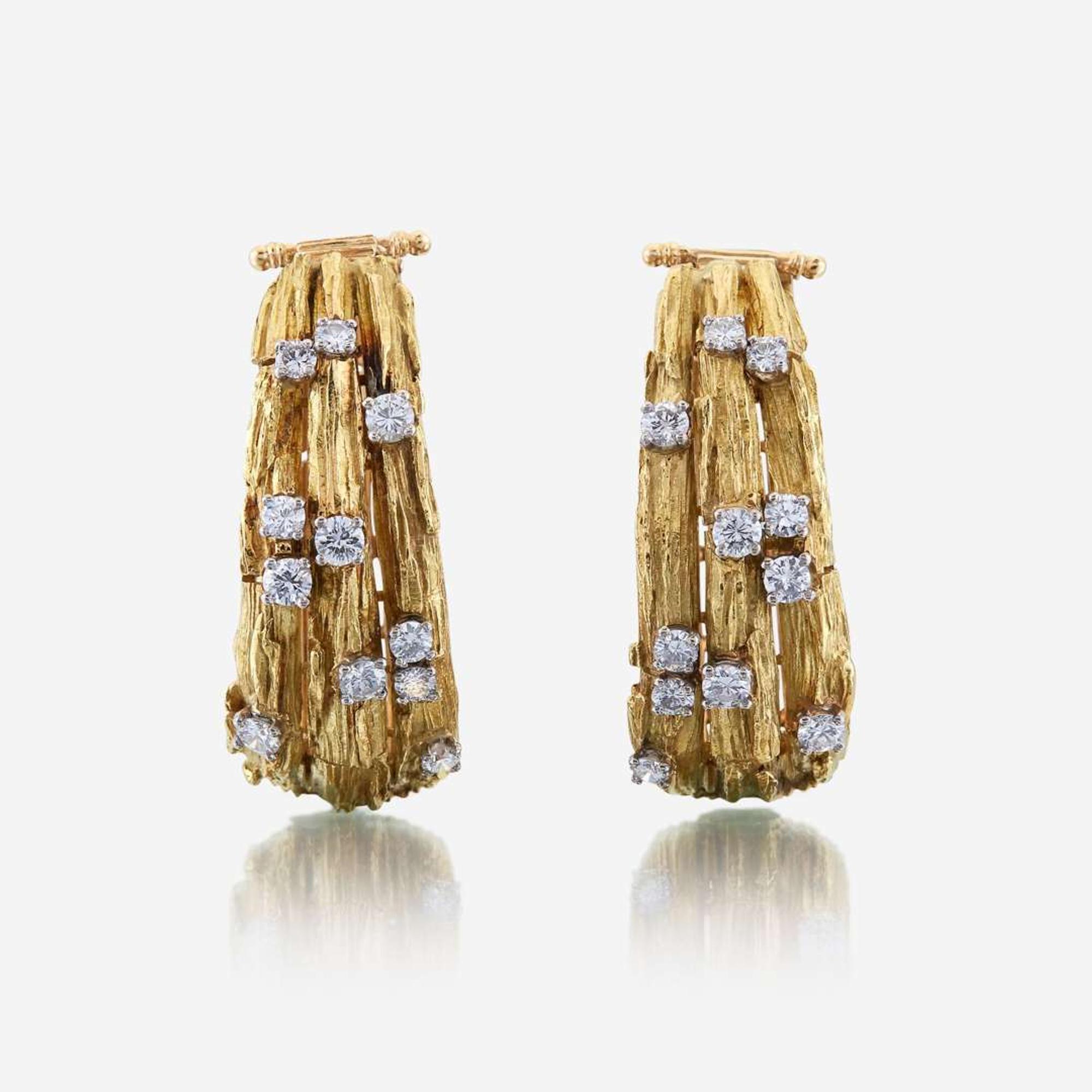 A pair of eighteen karat gold and diamond ear clips