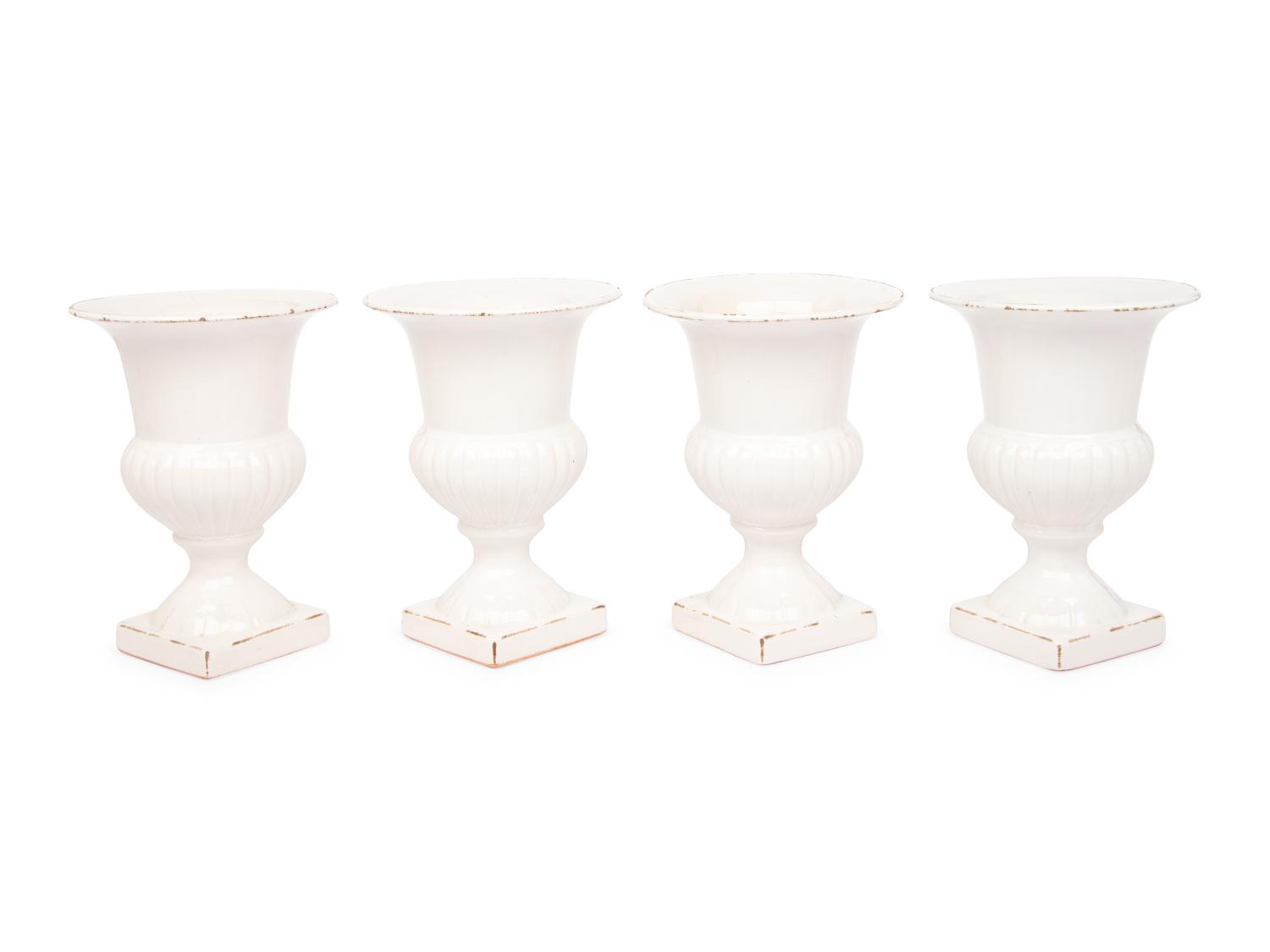 A Set of Four White Glazed Faience Urns