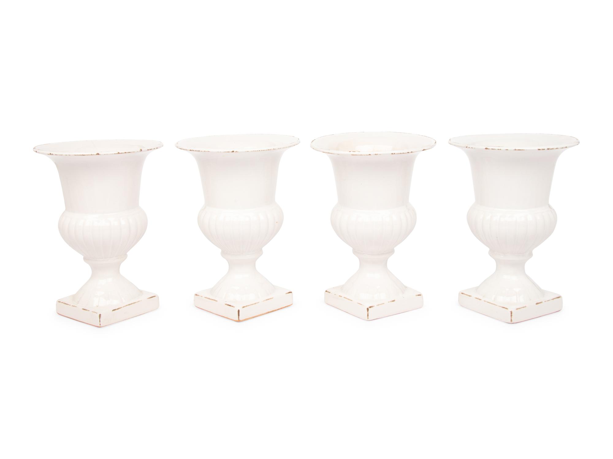 A Set of Four White Glazed Faience Urns