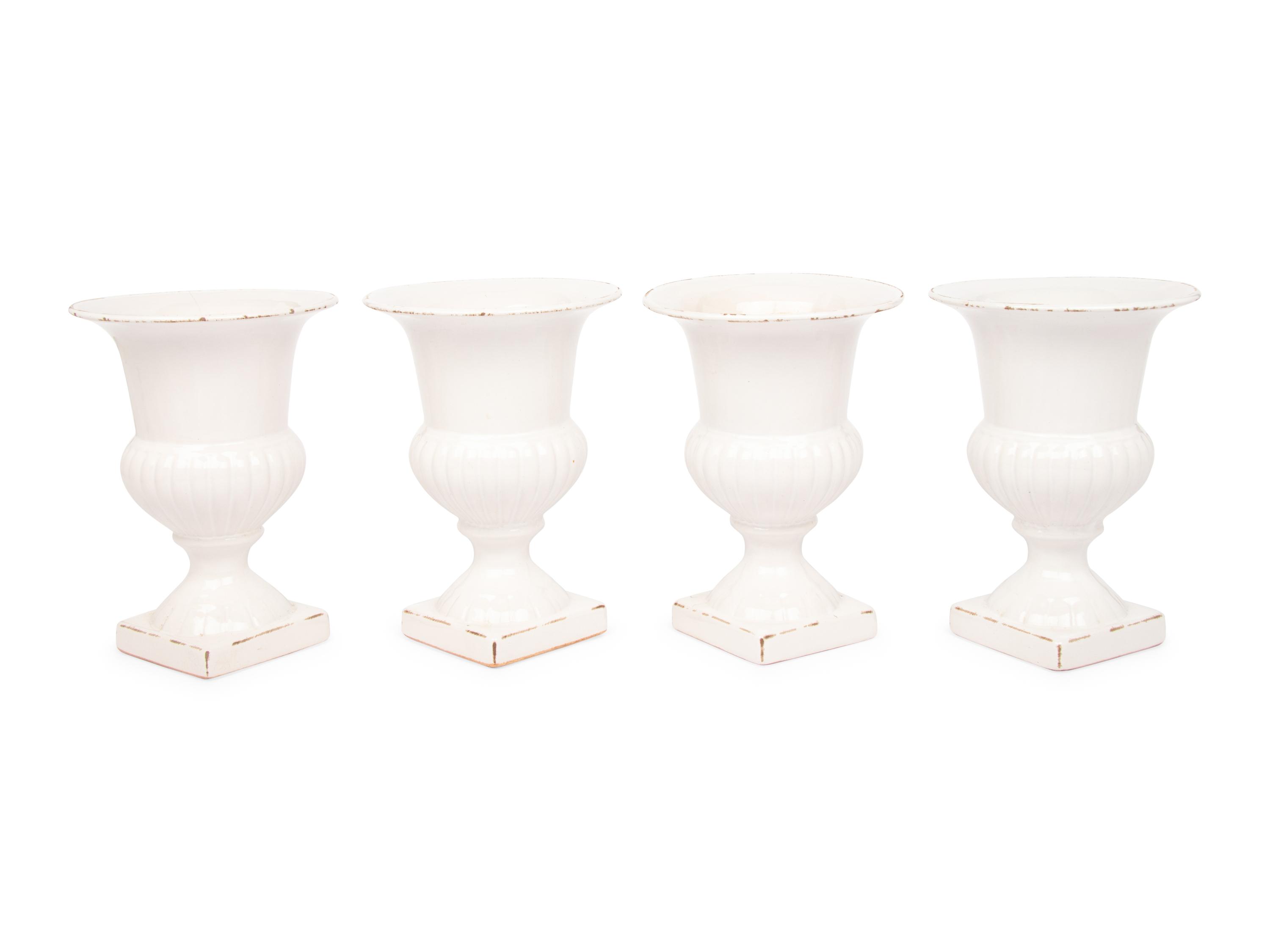 A Set of Four White Glazed Faience Urns