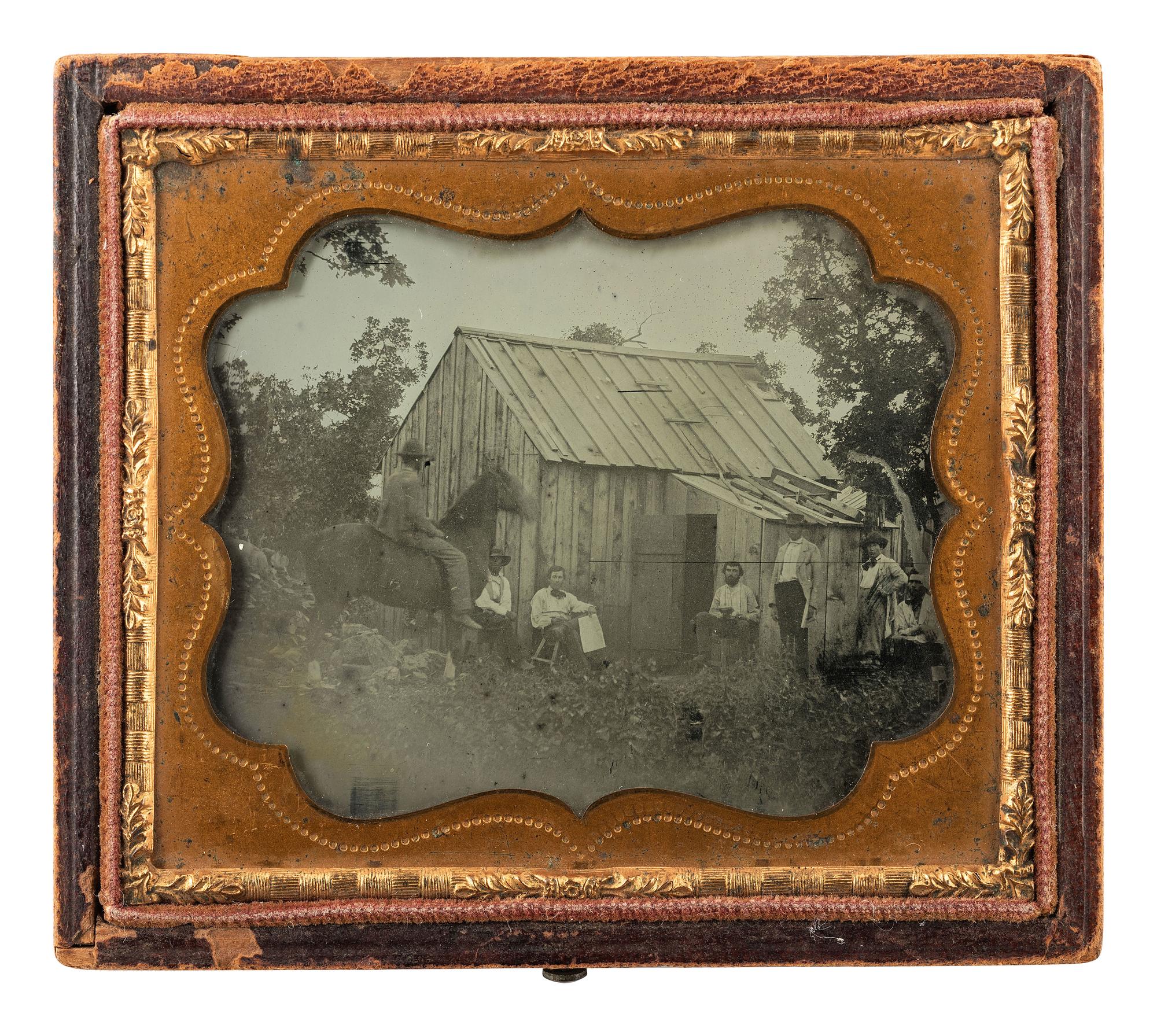 [MINING - EARLY PHOTOGRAPHY]. Sixth plate ambrotype of all male subjects posed outside of a cabin, possibly gold miners.