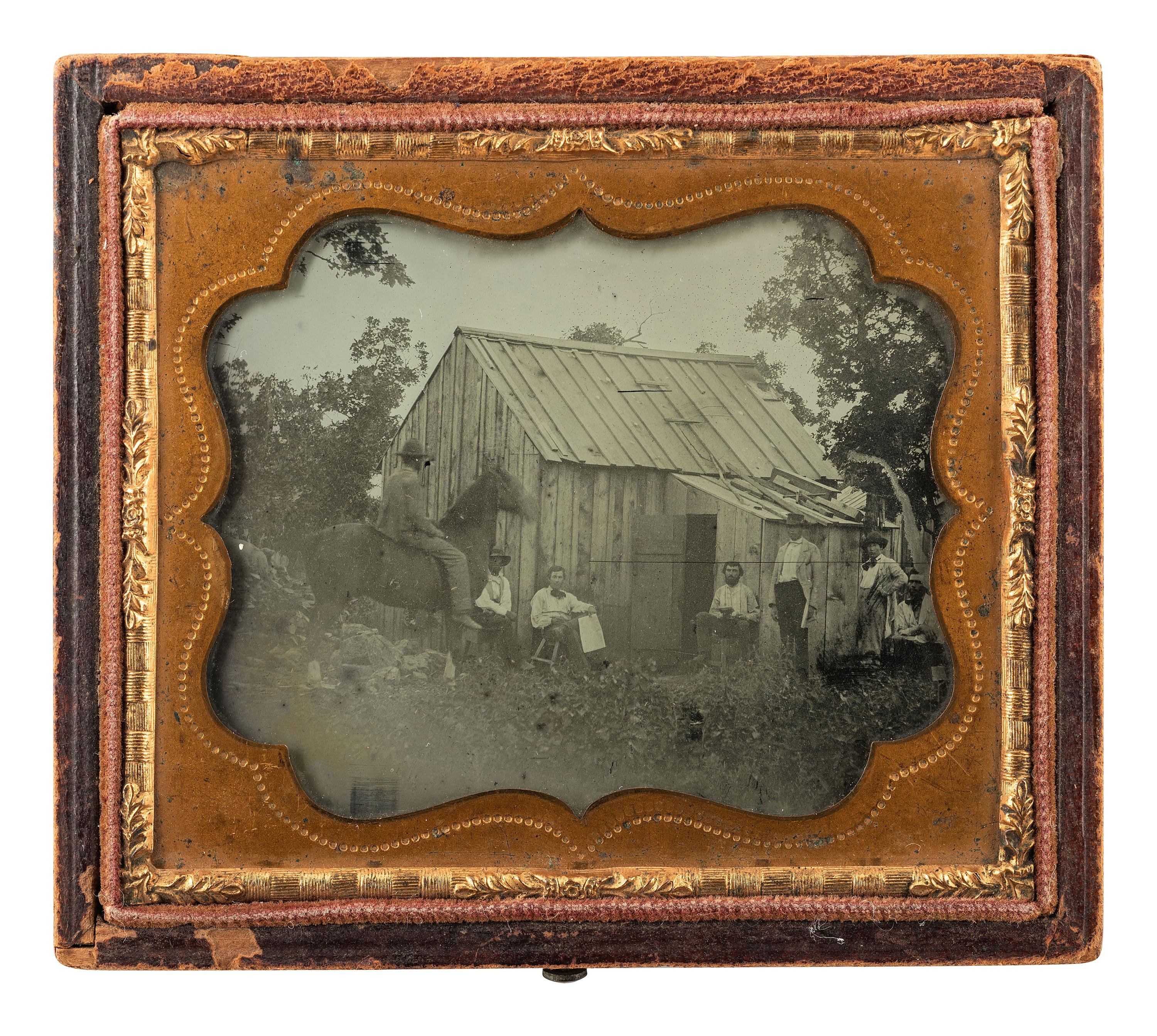 [MINING - EARLY PHOTOGRAPHY]. Sixth plate ambrotype of all male subjects posed outside of a cabin, possibly gold miners.