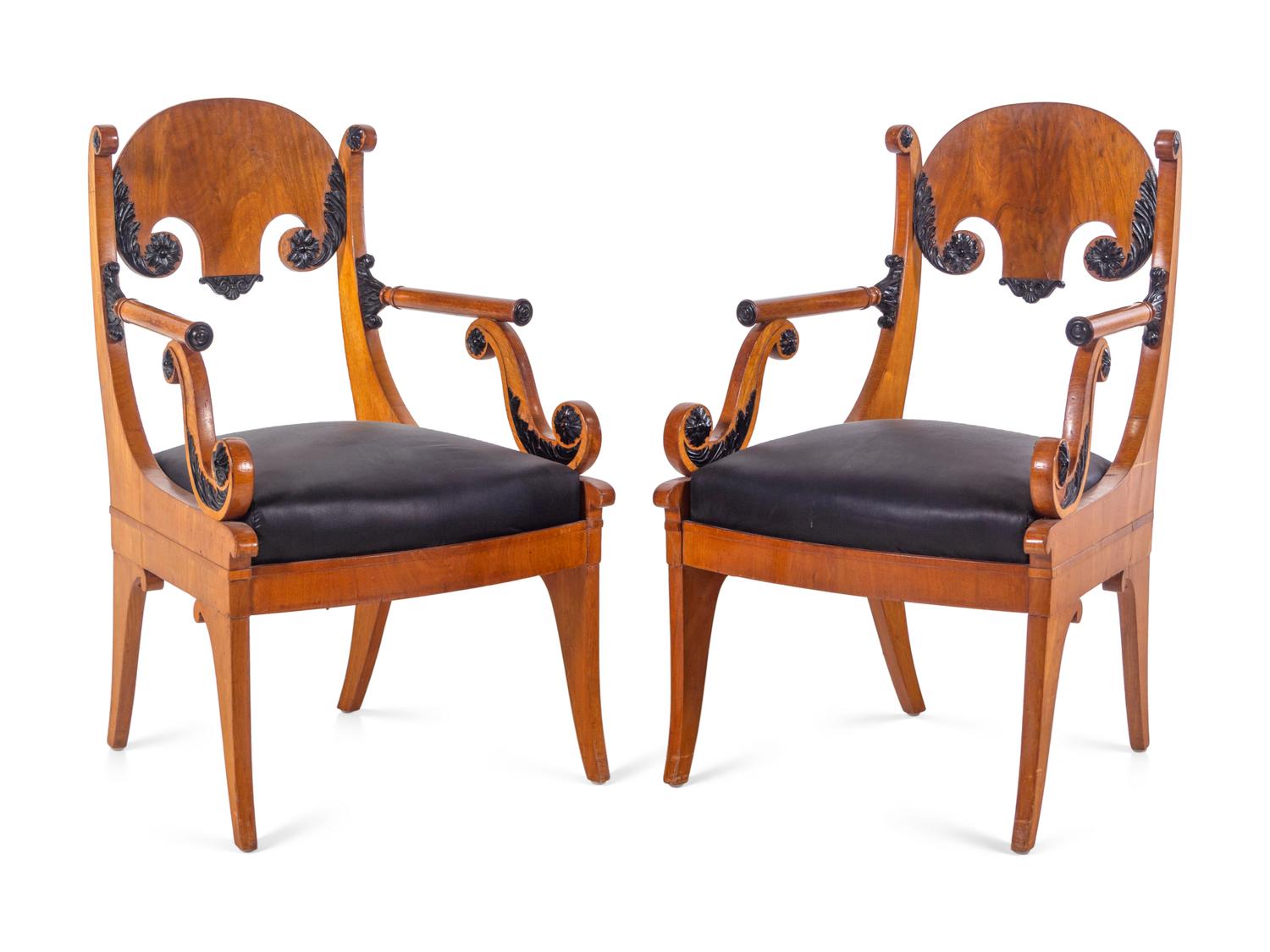 A Pair of Biedermeier Parcel Ebonized Armchairs